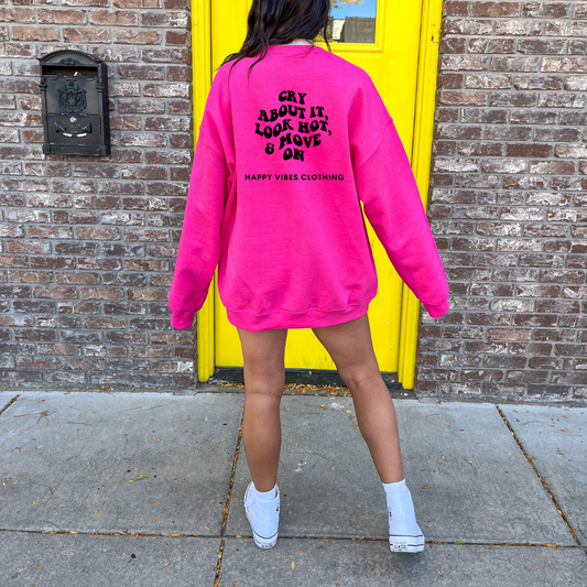 A girl wearing an oversized hot pink sweatshirt that says cry about it look hot & move on Happy Vibes Clothing